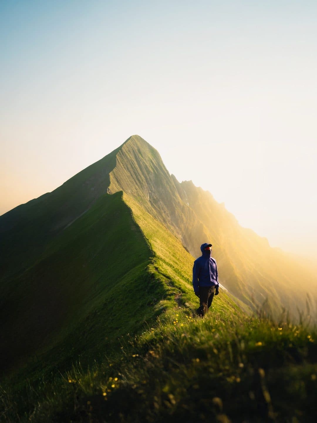 A hiker on the backlit Tannhorn ridge above Brienz