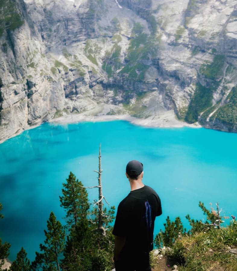 Turquoise Oeschinensee below steep cliffs near Kandersteg